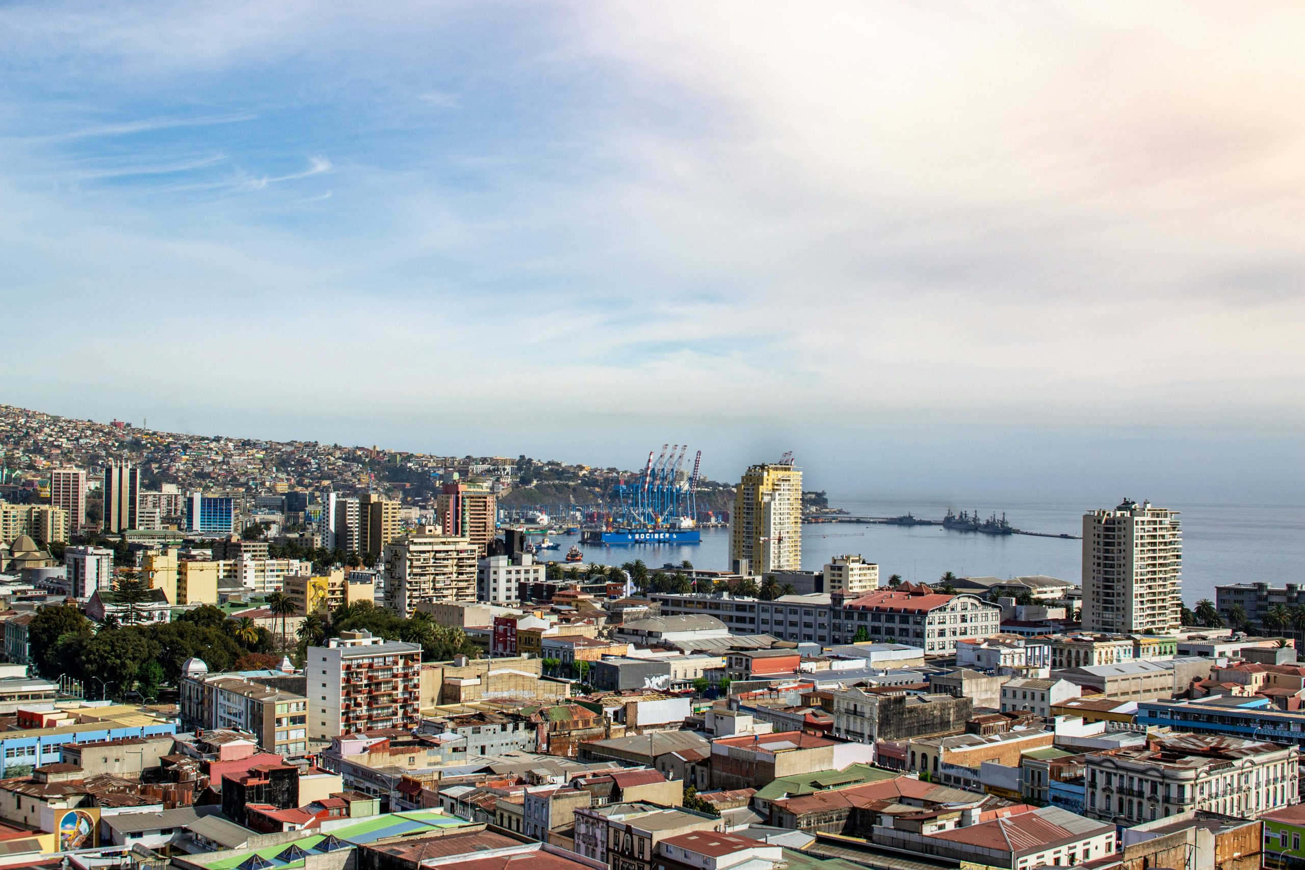 A scenic aerial view of Valparaíso, Chile, showcasing the city's vibrant architecture and bustling port.